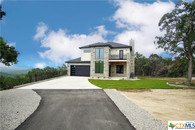 view of front facade with a front lawn, a garage, cooling unit, and a balcony