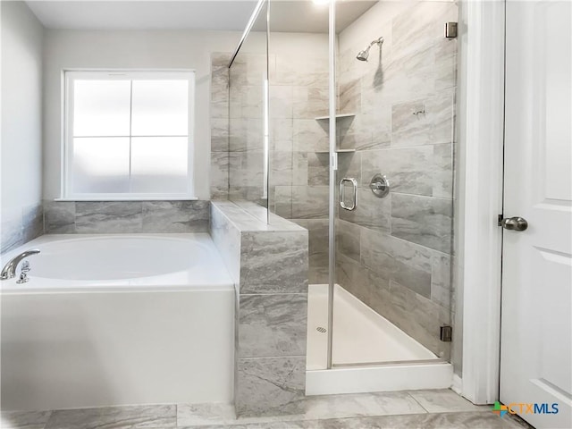 bathroom featuring independent shower and bath