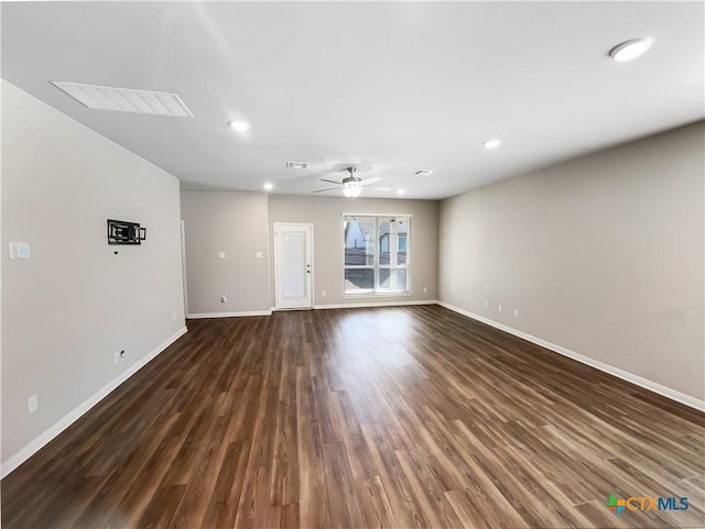 unfurnished living room featuring dark hardwood / wood-style flooring and ceiling fan