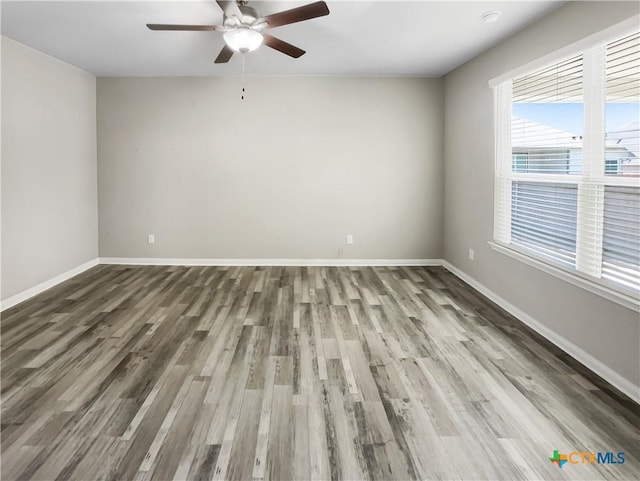 empty room featuring ceiling fan and wood-type flooring