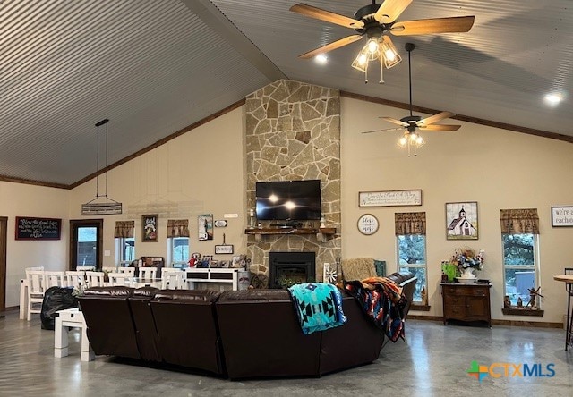 living room featuring a fireplace, ceiling fan, and high vaulted ceiling