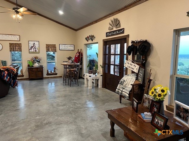 foyer entrance featuring a wealth of natural light, concrete floors, and ceiling fan