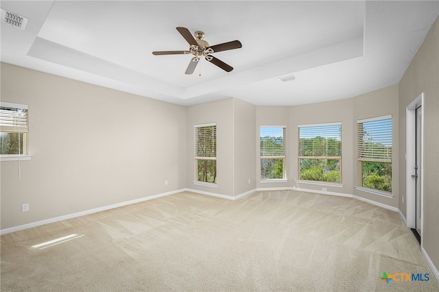 171 Clear Rdg, New Braunfels, TX 78132 - spare room featuring a tray ceiling, a wealth of natural light, visible vents, baseboards, and a ceiling fan
