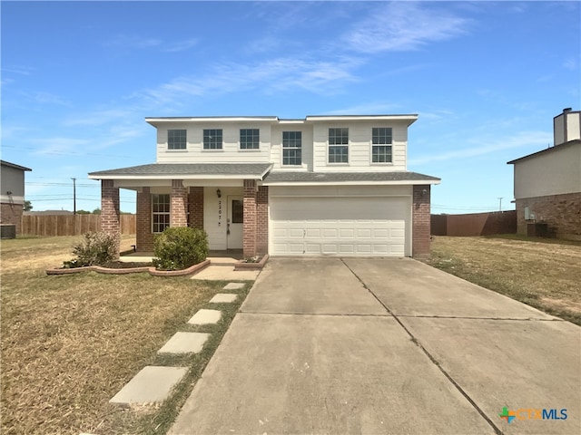 view of front property with a garage, a front yard, and a porch