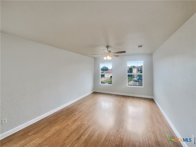 spare room featuring hardwood / wood-style floors and ceiling fan