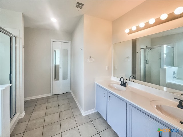 bathroom with tile patterned flooring, an enclosed shower, and vanity