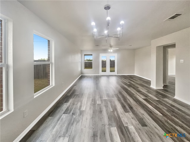 interior space with french doors, ceiling fan with notable chandelier, and dark hardwood / wood-style floors