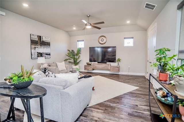 living room with dark hardwood / wood-style flooring, vaulted ceiling, and ceiling fan