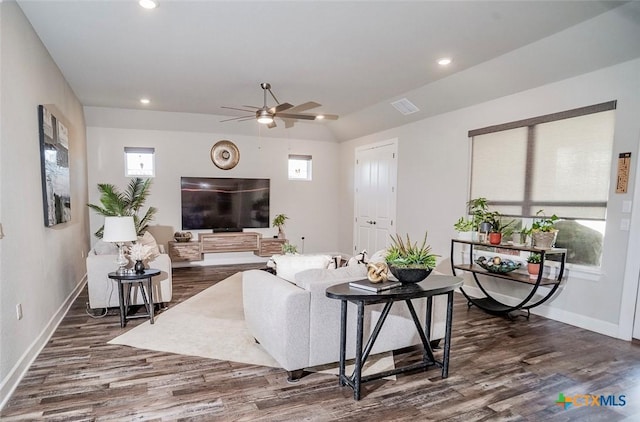 living room featuring dark hardwood / wood-style flooring, vaulted ceiling, and ceiling fan