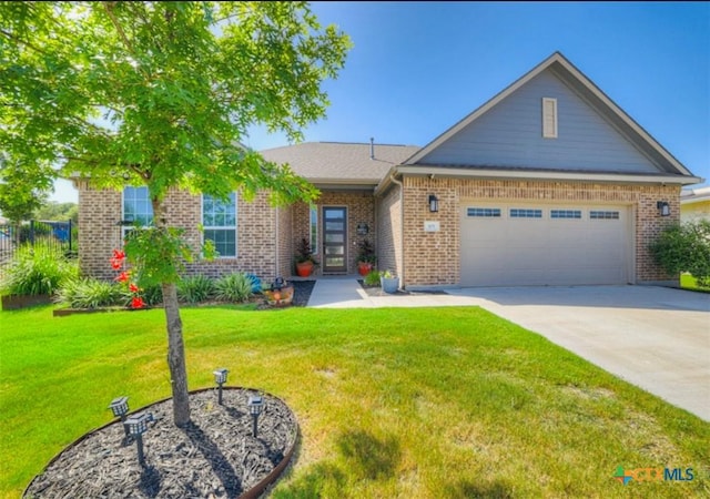 view of front of home with a garage and a front lawn