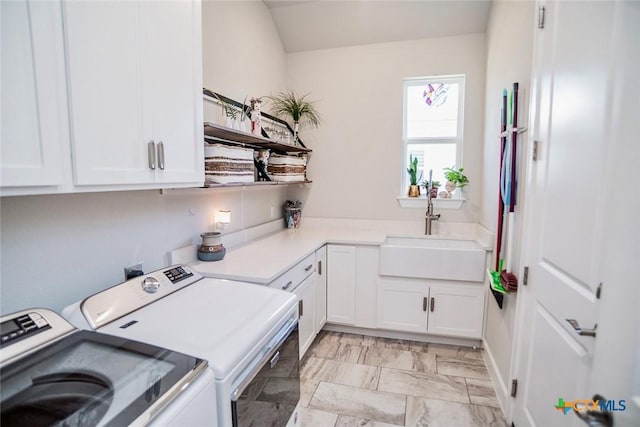 laundry room featuring sink, cabinets, and washer and dryer