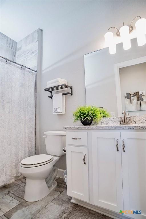 bathroom featuring vanity, toilet, and a shower with shower curtain