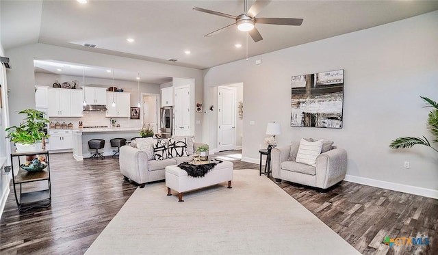 living room with ceiling fan, dark hardwood / wood-style floors, and vaulted ceiling