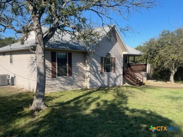1049 Summit Ridge Dr, New Braunfels, TX 78132 - view of side of home featuring a yard, central AC unit, stairway, and a jacuzzi