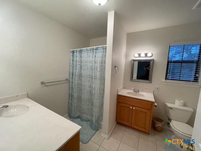 full bath featuring baseboards, toilet, a shower with curtain, tile patterned flooring, and vanity