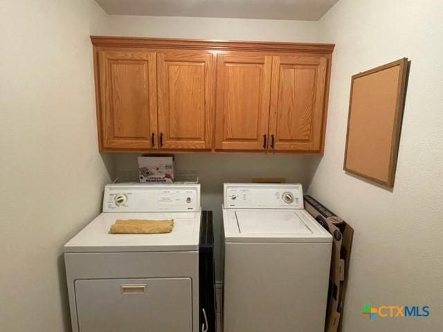 laundry area with cabinet space and independent washer and dryer