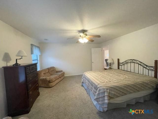 bedroom featuring light carpet, ceiling fan, and baseboards