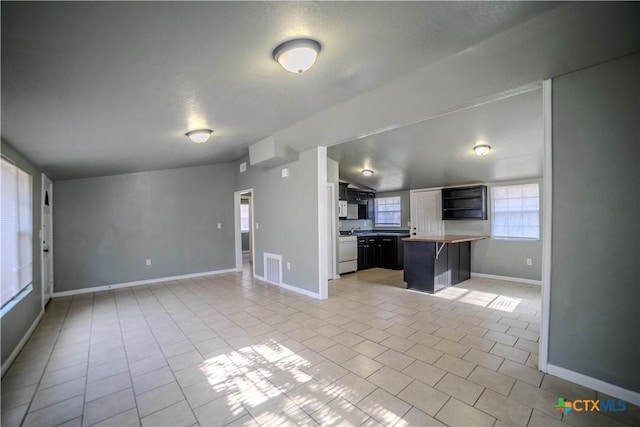 unfurnished living room with light tile patterned flooring