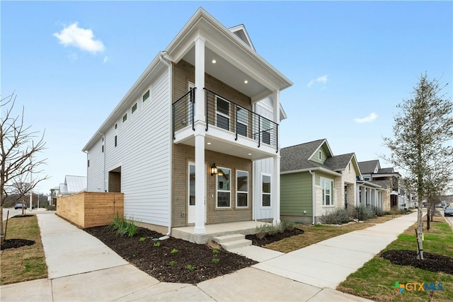 view of front facade with a balcony and covered porch