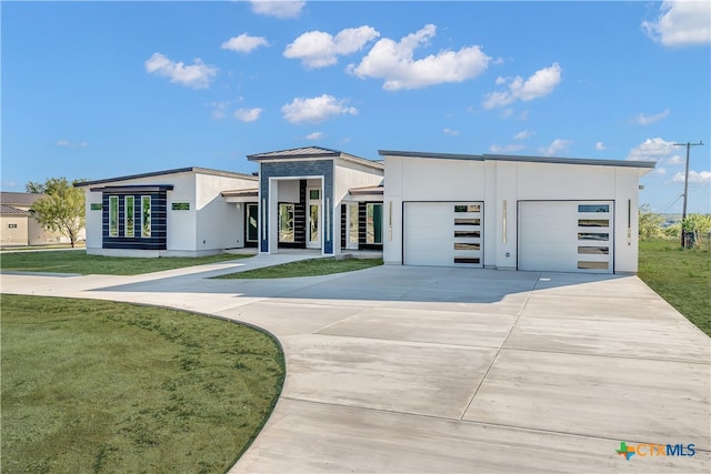 modern home with a front yard and a garage