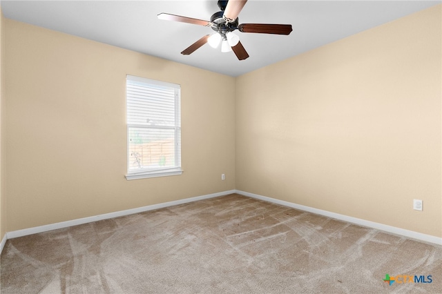 empty room featuring ceiling fan and light colored carpet