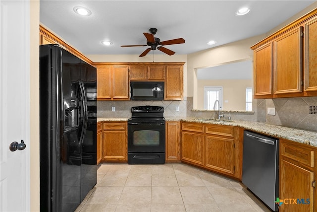 kitchen featuring backsplash, ceiling fan, sink, and black appliances