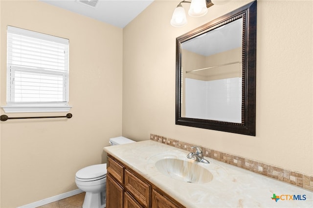 bathroom featuring tile patterned floors, a shower, vanity, and toilet