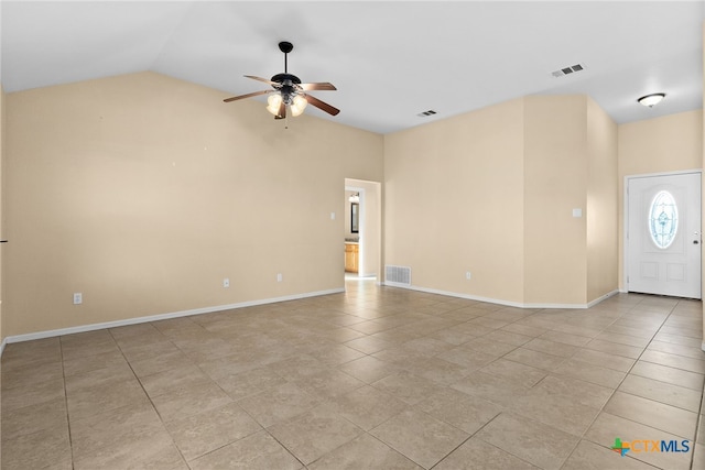 tiled empty room with ceiling fan and lofted ceiling