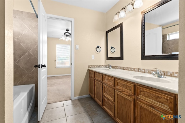 bathroom with tile patterned floors, vanity, and ceiling fan