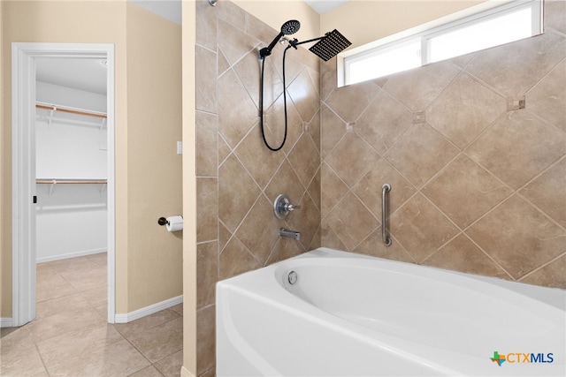 bathroom featuring tile patterned floors and tiled shower / bath