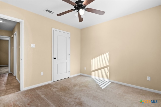 unfurnished bedroom with light colored carpet and ceiling fan