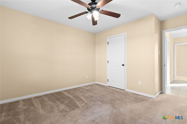 unfurnished bedroom featuring ceiling fan and light colored carpet