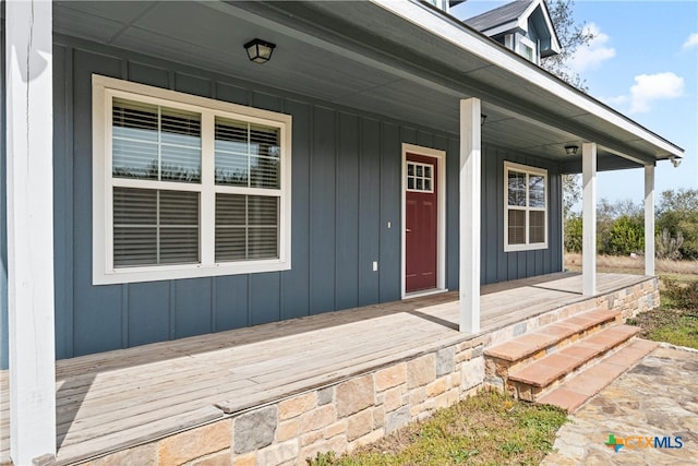 entrance to property featuring board and batten siding and a porch