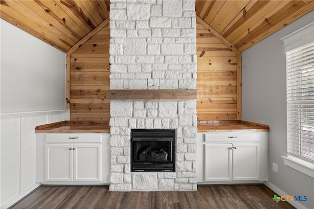 unfurnished living room with a stone fireplace, wood ceiling, and vaulted ceiling