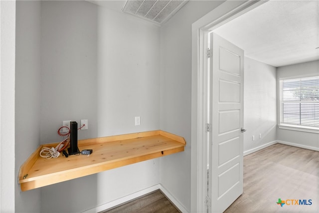 mudroom with visible vents, baseboards, and wood finished floors