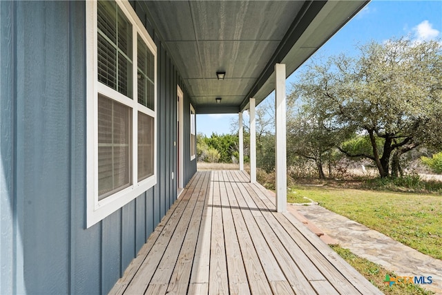 deck with a lawn and a porch