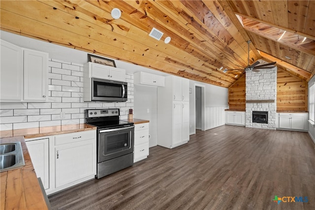 kitchen featuring white cabinetry, wood ceiling, dark wood-style flooring, and appliances with stainless steel finishes