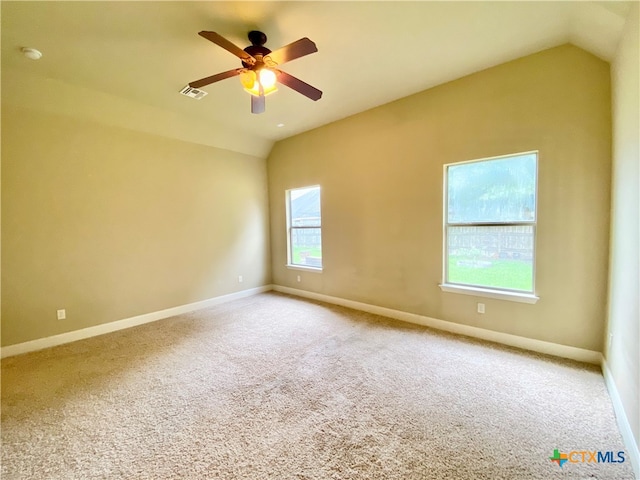 carpeted spare room with lofted ceiling and ceiling fan