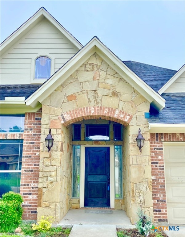 view of exterior entry with a garage