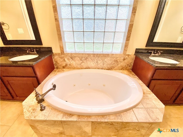 bathroom featuring vanity and tiled bath