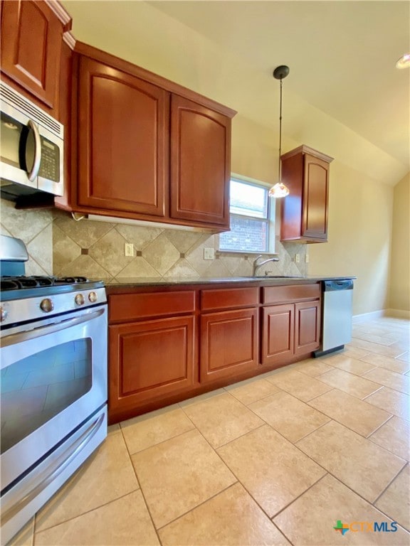 kitchen featuring stainless steel appliances, light tile patterned floors, pendant lighting, and decorative backsplash