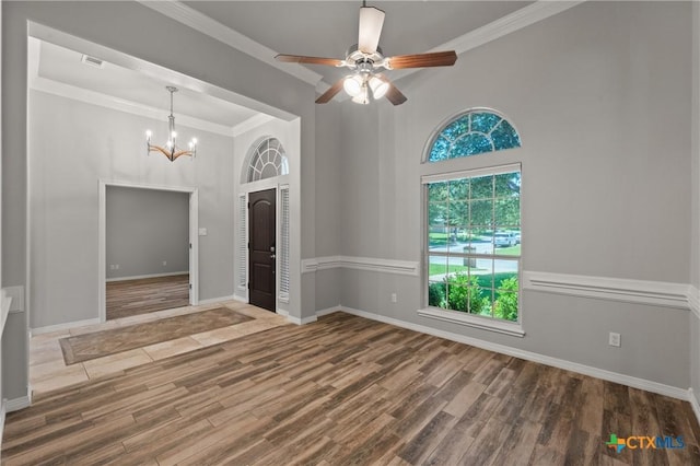 5905 Turtle Creek Trl, Temple, TX 76502 - entrance foyer with wood finished floors, a chandelier, a ceiling fan, ornamental molding, and baseboards