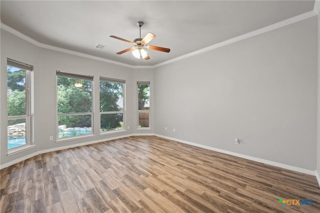 5905 Turtle Creek Trl, Temple, TX 76502 - empty room with plenty of natural light, wood finished floors, ceiling fan, baseboards, and crown molding