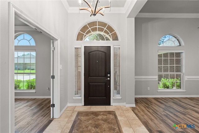 5905 Turtle Creek Trl, Temple, TX 76502 - entryway featuring a chandelier, plenty of natural light, wood finished floors, crown molding, and baseboards