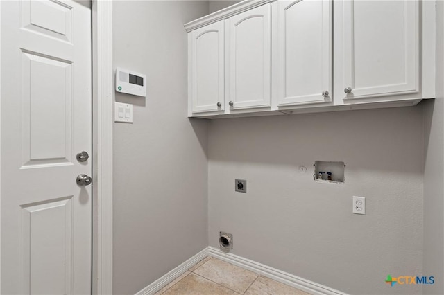 5905 Turtle Creek Trl, Temple, TX 76502 - laundry area featuring cabinet space, electric dryer hookup, baseboards, hookup for a gas dryer, and light tile patterned flooring