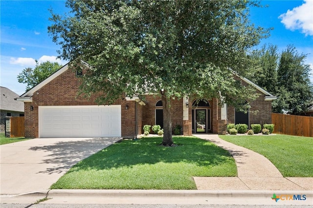 5905 Turtle Creek Trl, Temple, TX 76502 - obstructed view of property with an attached garage, driveway, and brick siding