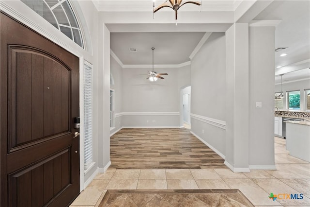 5905 Turtle Creek Trl, Temple, TX 76502 - entryway with arched walkways, crown molding, ceiling fan, baseboards, and light wood finished floors