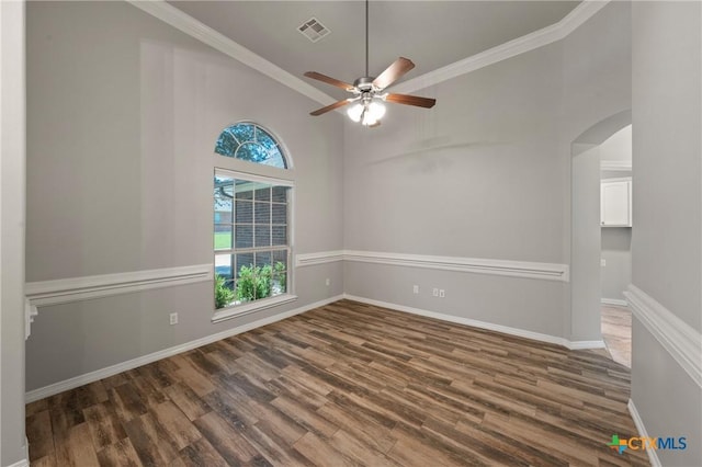5905 Turtle Creek Trl, Temple, TX 76502 - empty room with arched walkways, wood finished floors, a ceiling fan, ornamental molding, and baseboards