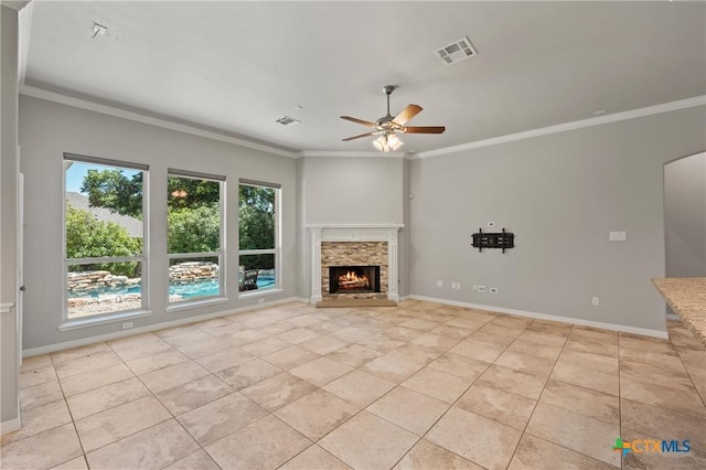 5905 Turtle Creek Trl, Temple, TX 76502 - unfurnished living room featuring light tile patterned flooring, a ceiling fan, ornamental molding, a stone fireplace, and baseboards
