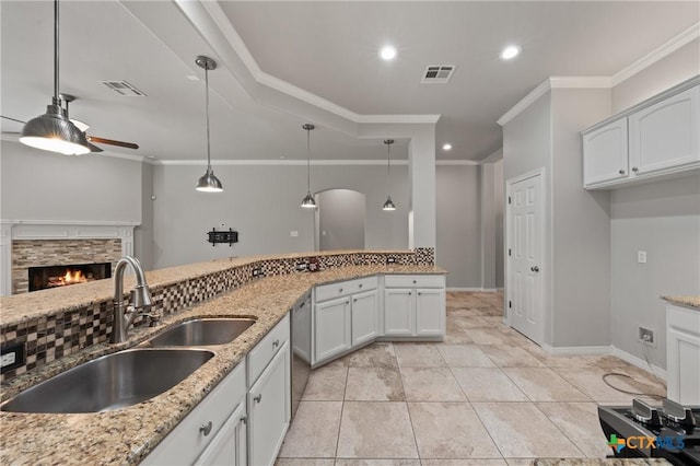 5905 Turtle Creek Trl, Temple, TX 76502 - kitchen featuring a sink, ceiling fan, stainless steel dishwasher, ornamental molding, and a fireplace